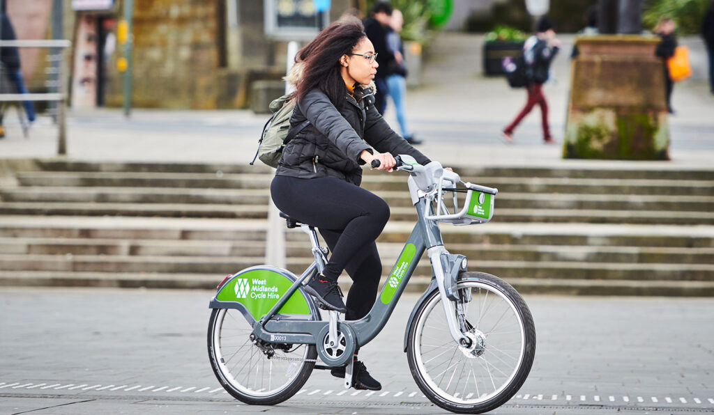 West Midlands Cycle Hire Photography, Woman riding bicycle in street