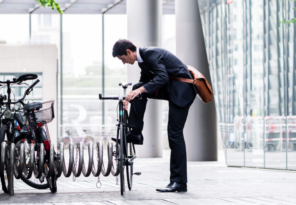 Photo of a business person arriving for work by bicycle